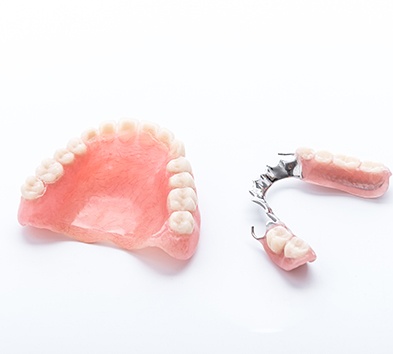 Full dentures and partial dentures on white background