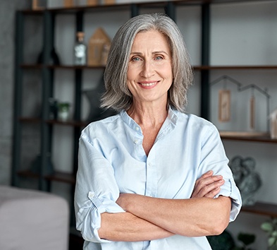 Senior woman smiling with arms folded