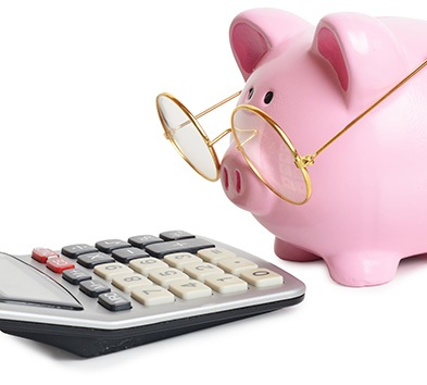 Piggy bank with glasses using a calculator to figure out the cost of teeth whitening