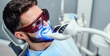 Young man receiving in-office teeth whitening